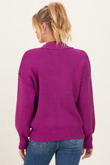 woman wearing a magenta maternity sweater with a relaxed fit and balloon sleeves, showing the back view
