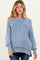 woman wearing a light blue striped maternity sweater with a relaxed fit and side slits