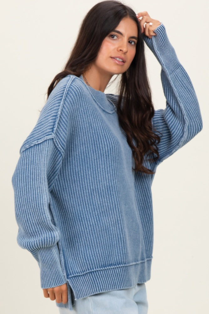 woman wearing a oversized blue ribbed sweater with long sleeves and a relaxed fit