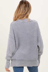 woman wearing a gray ribbed oversized maternity sweater, view from the back