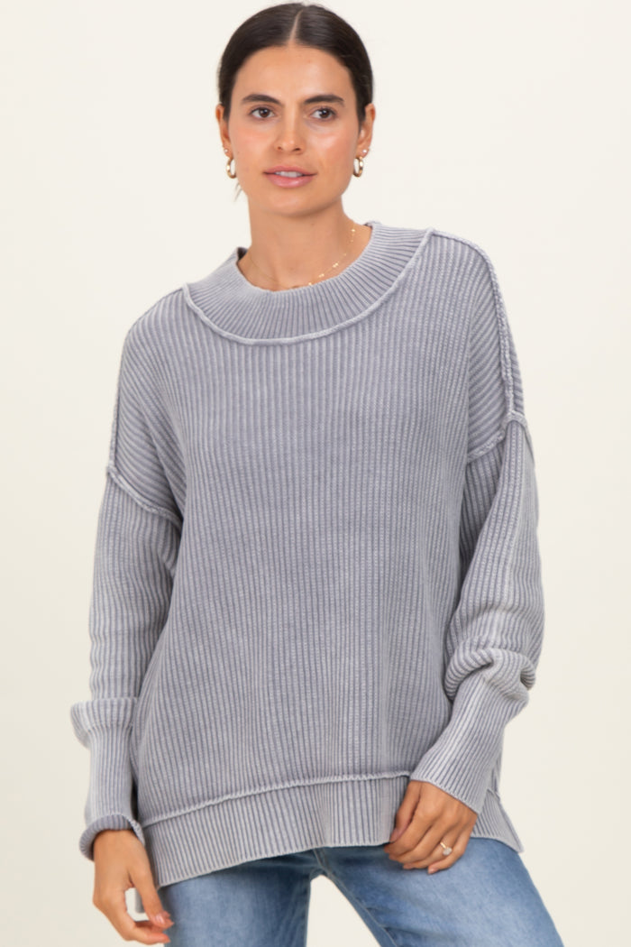 woman wearing a cozy gray ribbed sweater with a relaxed fit and dropped shoulders