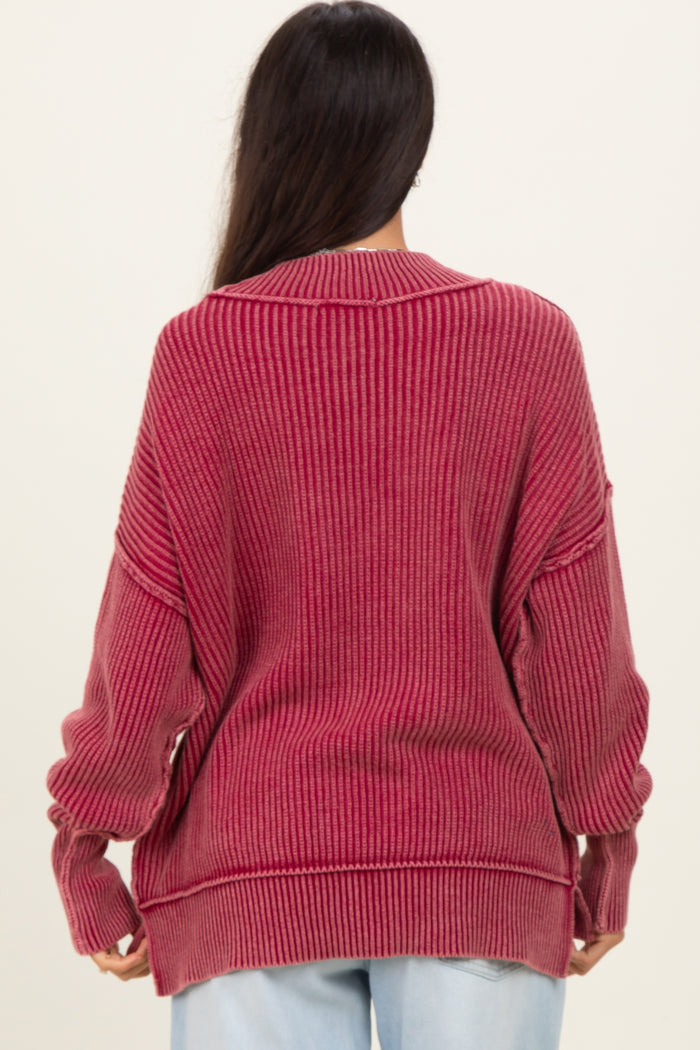 woman wearing a ribbed oversized maroon sweater with a relaxed fit and dropped shoulder seams