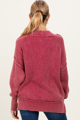 woman wearing a burgundy striped oversized maternity sweater viewed from the back