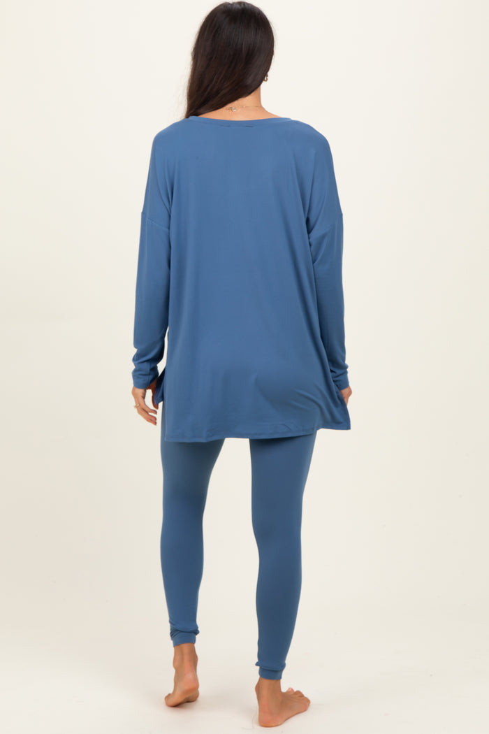 woman wearing a blue long sleeve tunic top and matching leggings, seen from the back