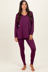 woman wearing a long sleeve v-neck purple top and matching purple leggings