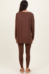 woman wearing a long brown tunic top and matching leggings, viewed from the back