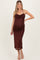 woman wearing a burgundy maternity dress with a cowl neckline and fitted silhouette, highlighting her baby bump