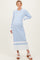 woman wearing a light blue striped maternity dress with a collared neckline and long sleeves, showing her baby bump