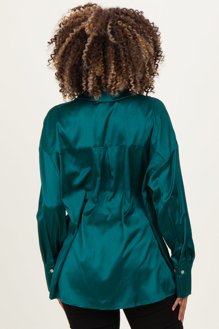 woman wearing a teal maternity satin shirt with a relaxed fit and long sleeves, showing a slight baby bump from the back