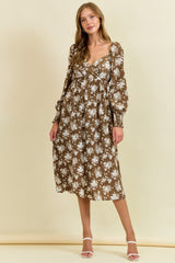 woman wearing a brown floral midi dress with long sleeves and a loose fit, standing against a beige background
