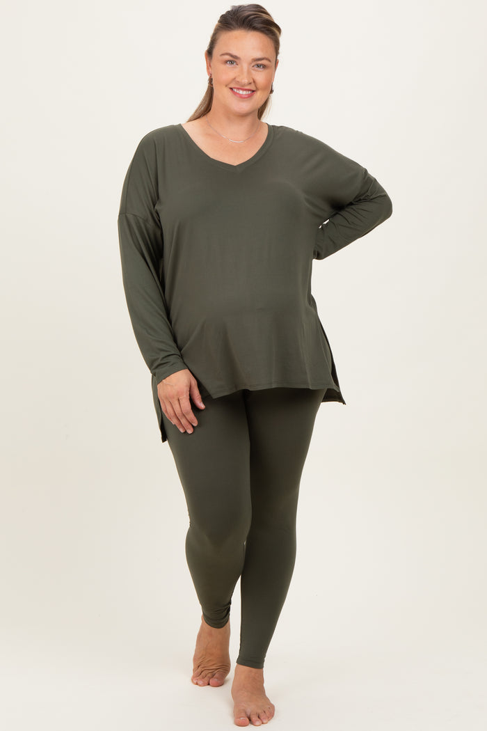 woman wearing a green maternity plus long sleeve top and matching leggings, showing her baby bump