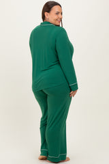 woman wearing a green long sleeve plus size pajama set with white piping, showing a relaxed fit from the back