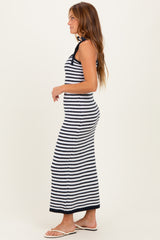 woman wearing a navy and white striped long maxi dress with a fitted silhouette and halter neck design