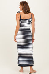 woman wearing a navy and white striped long maxi dress with adjustable straps