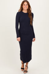 woman wearing a navy blue ribbed long sleeve midi dress and black strappy heels
