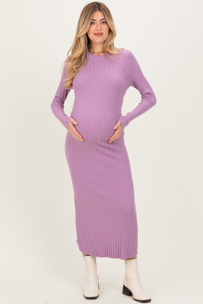 woman wearing a lavender long sleeve ribbed maternity dress and holding her baby bump