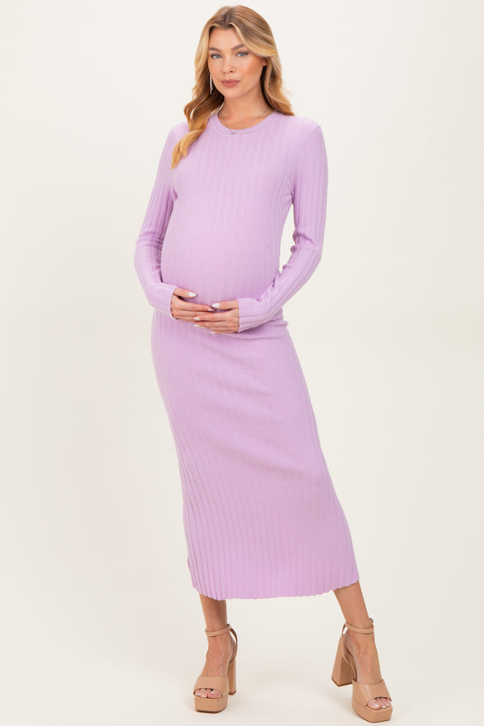 woman wearing a light purple ribbed maternity dress and holding her baby bump