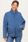 woman wearing a blue quilted maternity jacket with a high collar and side pockets