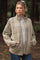 woman wearing a light beige quilted maternity jacket over a striped top, standing outdoors with hands in pockets