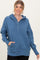 woman wearing a blue oversized hoodie with button details and front pocket