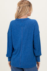 woman wearing a blue oversized ribbed sweater with a back seam detail