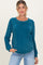 woman wearing a teal long sleeve maternity sweater with a relaxed fit and a round neckline