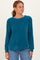 woman wearing a teal long sleeve waffle knit sweater with a relaxed fit and round neckline