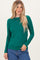 woman wearing a green long sleeve top and blue jeans