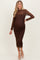woman wearing a brown lace long sleeve maternity dress that fits snugly over her baby bump
