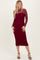 woman wearing a burgundy lace long sleeve midi dress with a fitted silhouette and a sheer lace neckline