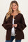 woman wearing a brown maternity cardigan with oversized sleeves and buttons, showcasing her baby bump