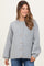 woman wearing a light gray oversized button-up maternity sweater with balloon sleeves and a round neckline