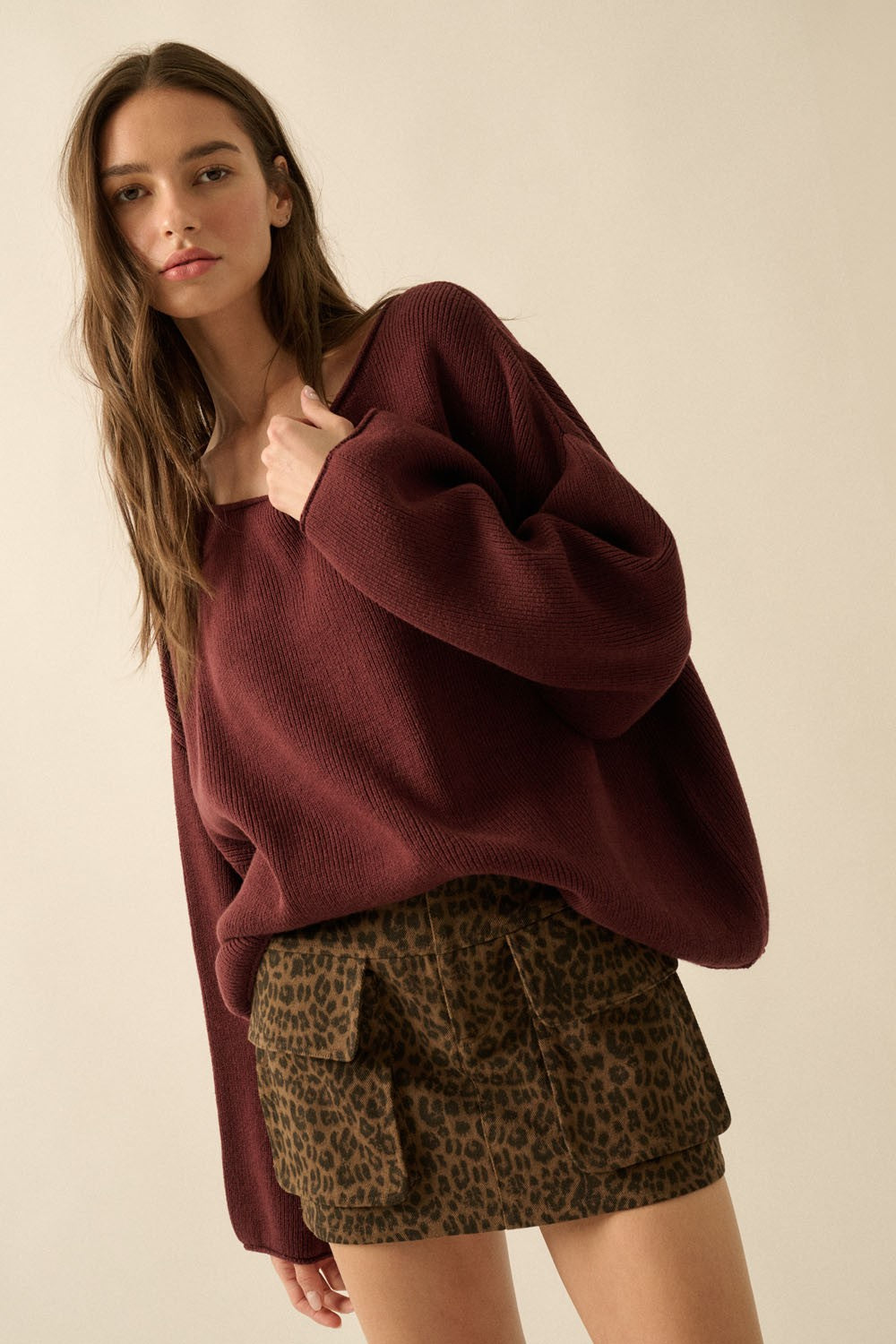woman wearing a burgundy oversized sweater and a brown leopard print mini skirt