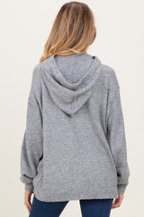 woman wearing a cozy grey maternity hoodie with a relaxed fit and a hood, showing the back view