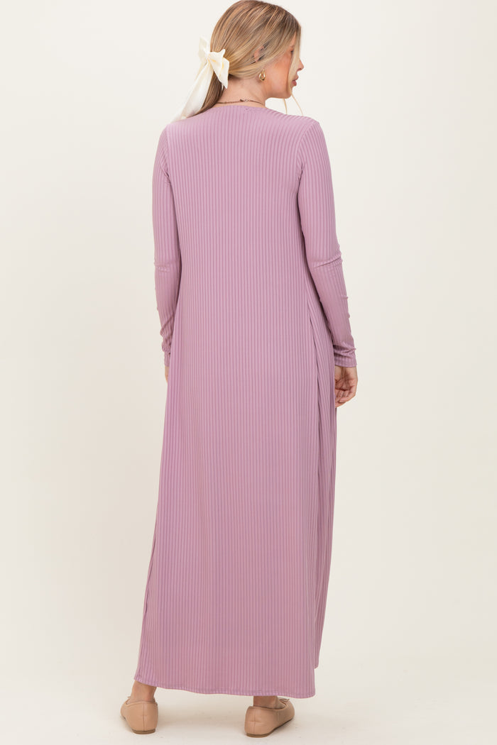 woman wearing a long lavender ribbed maxi dress with long sleeves and a side slit, viewed from the back