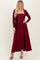 woman wearing a burgundy ribbed midi dress with a long open cardigan and strappy black heels