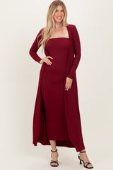 woman wearing a burgundy ribbed maxi dress with a matching long cardigan and strappy heels