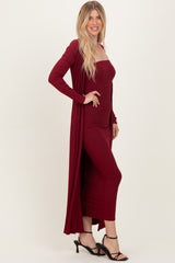woman wearing a burgundy ribbed maxi dress with matching long cardigan and black strappy heels
