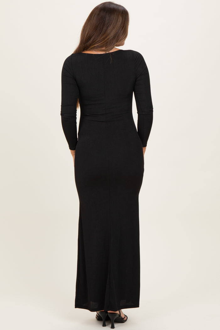 woman wearing a black long sleeve maternity maxi dress, showcasing a fitted style and back view