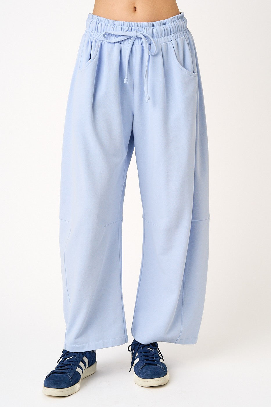 woman wearing light blue wide-leg sweatpants with an elastic waistband and pockets