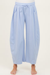 woman wearing light blue maternity wide-leg lounge pants with pockets and adjustable drawstring waist