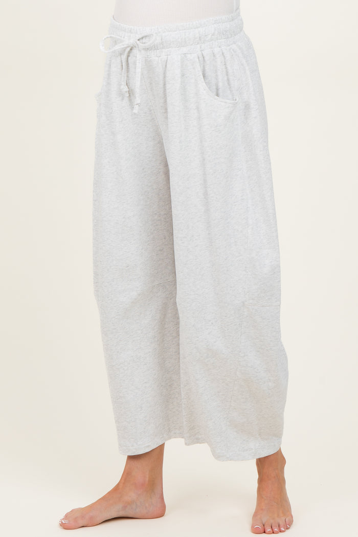 woman wearing light grey wide-leg maternity pants with pockets and an elastic waistband