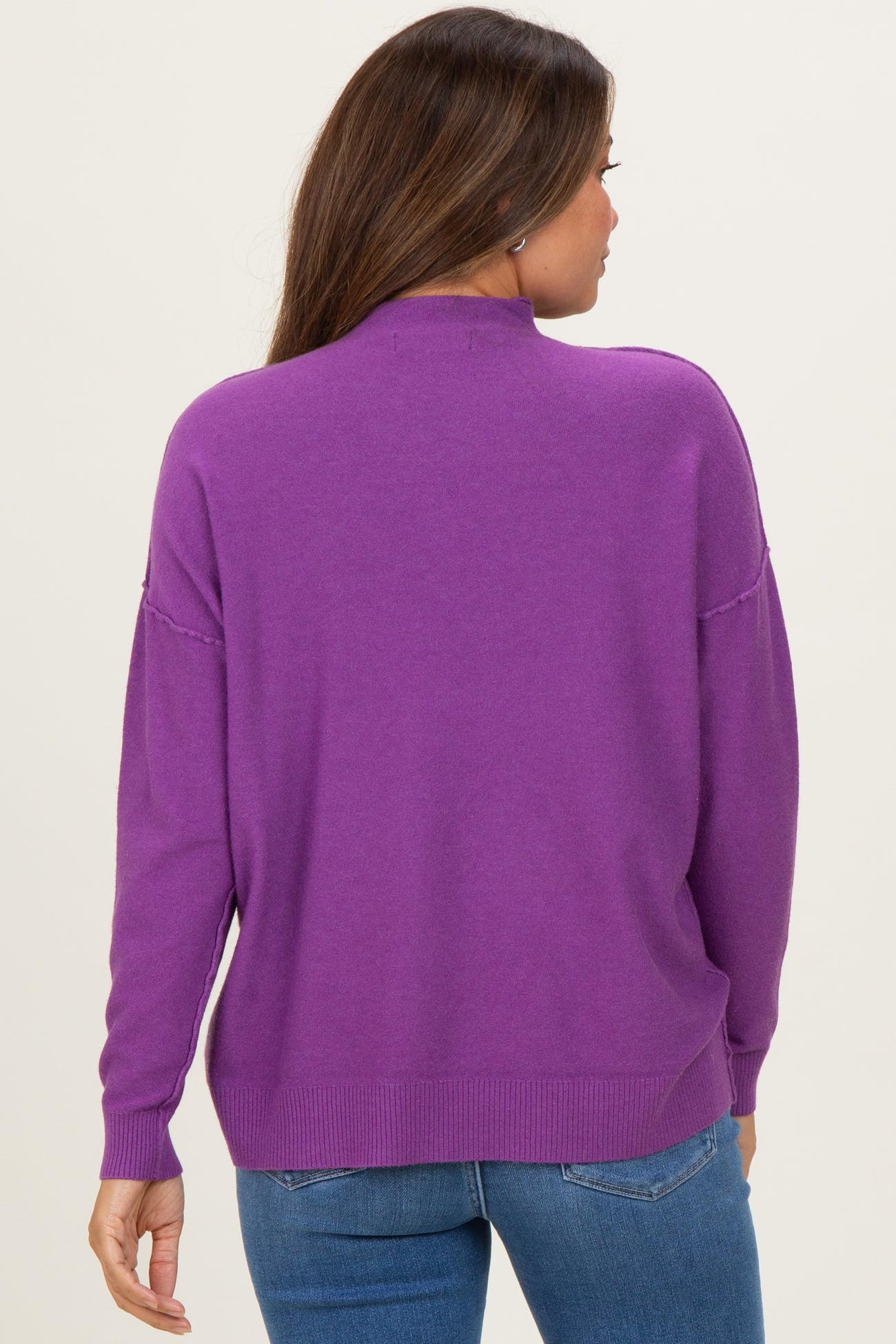 woman wearing a purple maternity sweater, showing the back view with relaxed fit and long sleeves