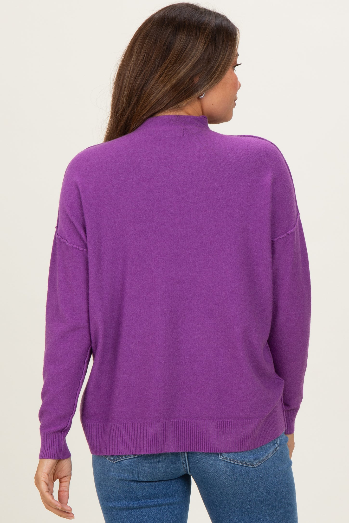 woman wearing a purple maternity sweater, showing the back view with relaxed fit and long sleeves