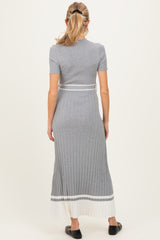 woman wearing a grey ribbed maternity dress with short sleeves and pleated hem, showing her baby bump from the back