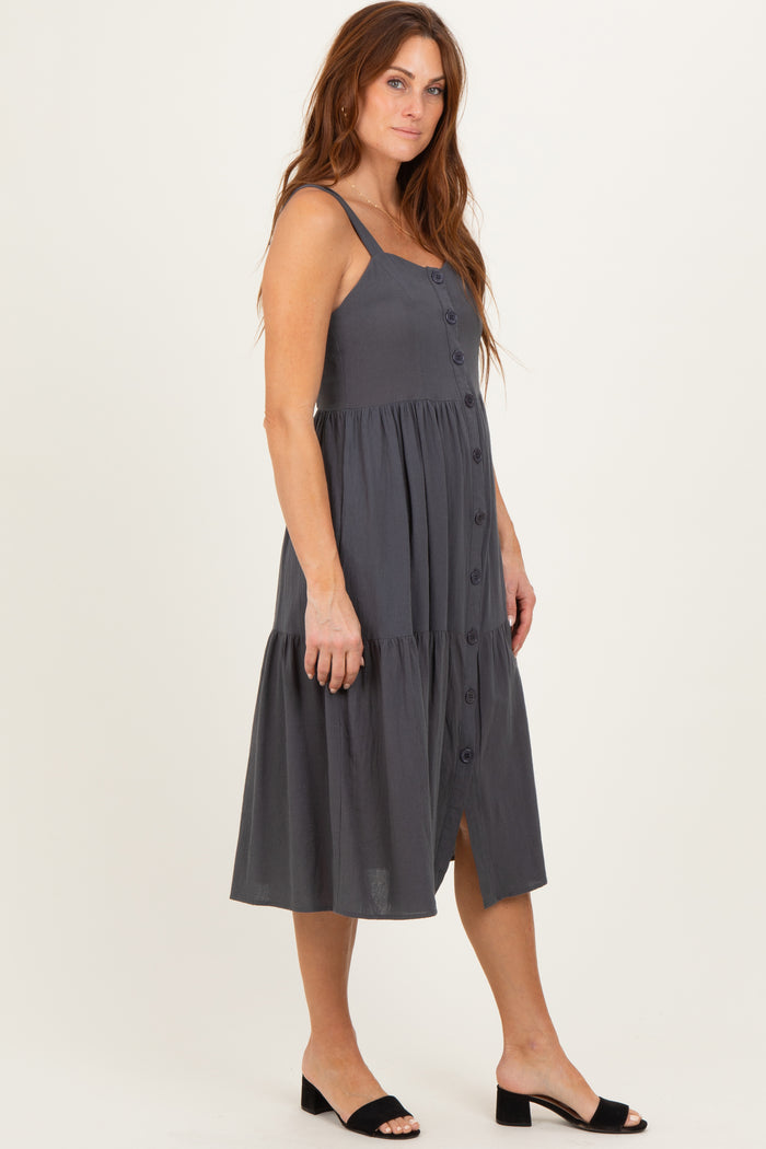 woman wearing a charcoal gray button-up midi dress with a tiered hem and thin straps