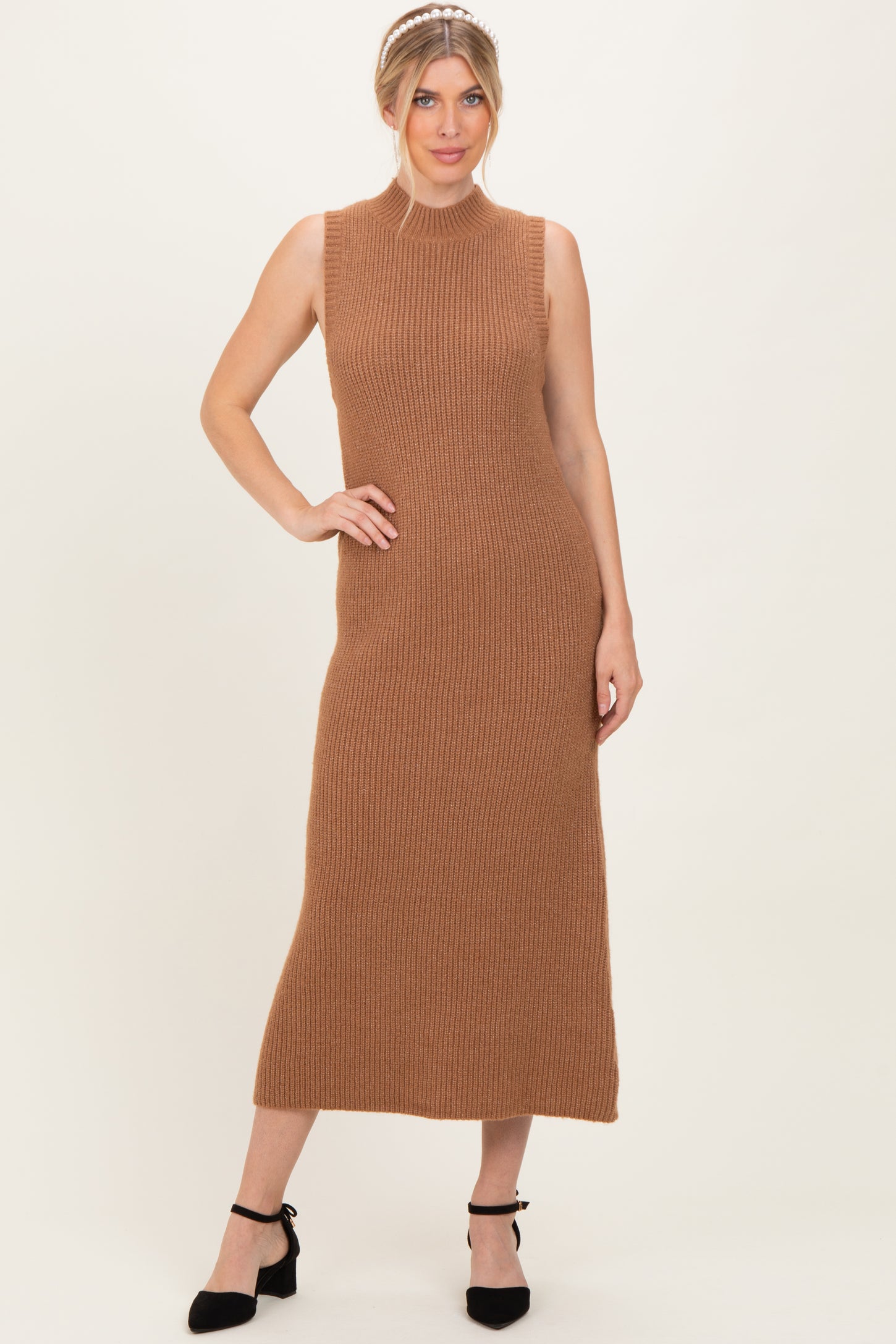woman wearing a ribbed sleeveless brown maxi dress styled with black ankle strap heels