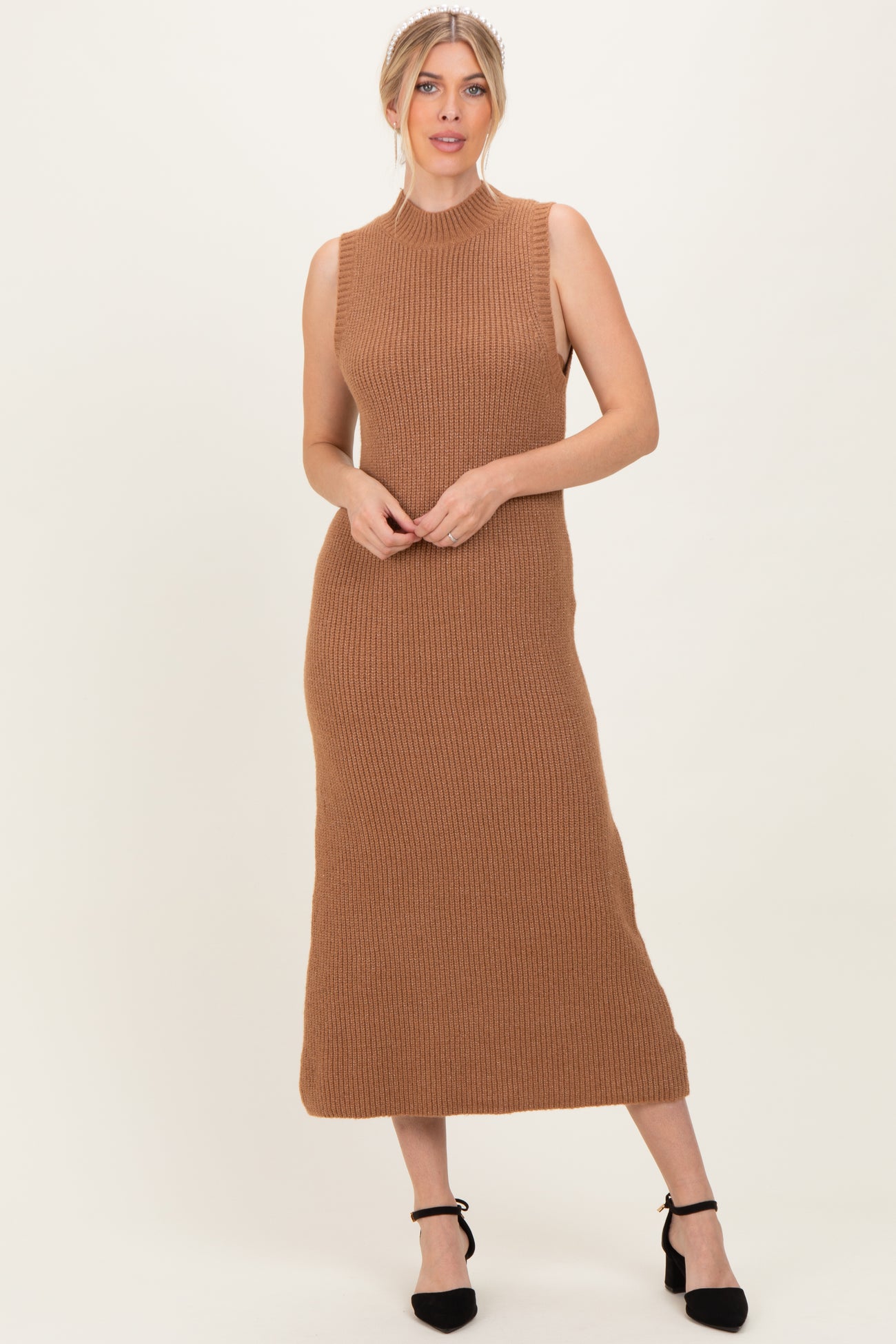 woman wearing a camel ribbed knit sleeveless maxi dress with a high neckline and a fitted silhouette