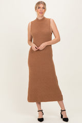 woman wearing a camel ribbed knit sleeveless maxi dress with a high neckline and a fitted silhouette