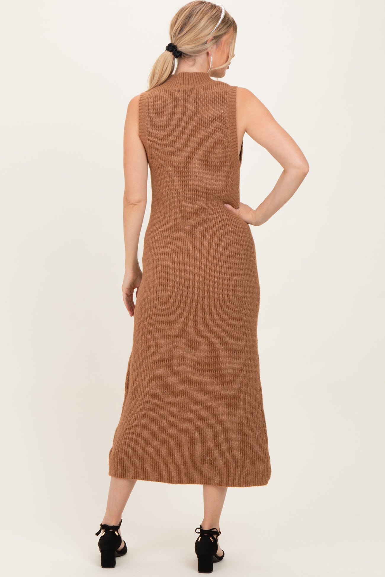 woman wearing a tan ribbed knit sleeveless midi dress, shown from the back